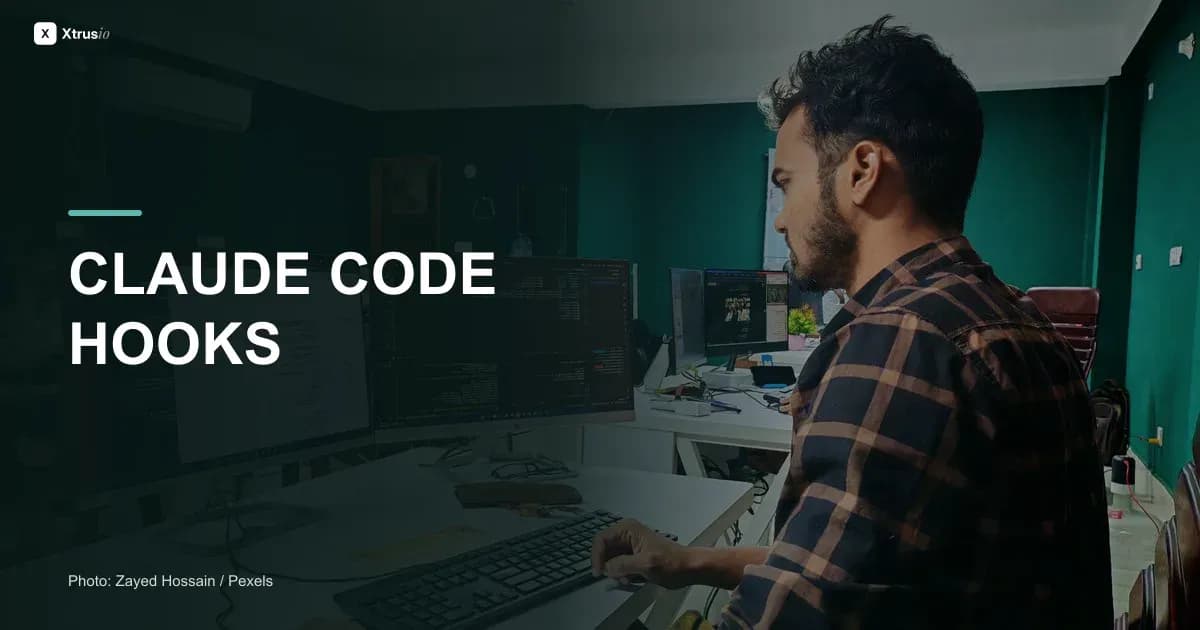Developer working at multiple monitors beside the headline Claude Code Hooks